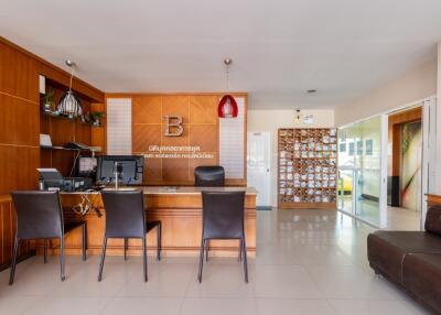 Modern office reception area with desk, chairs, and décor