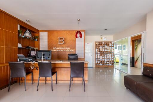 Modern office reception area with desk, chairs, and décor