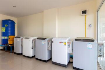 Laundry room with multiple washing machines