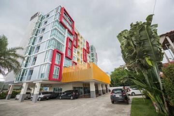 Modern multi-story apartment building with parking area