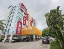 Modern multi-story apartment building with parking area