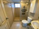 Modern bathroom with a glass-enclosed shower and tiled walls