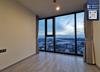 Modern living room with large floor-to-ceiling windows and a city view