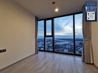 Modern living room with large floor-to-ceiling windows and a city view