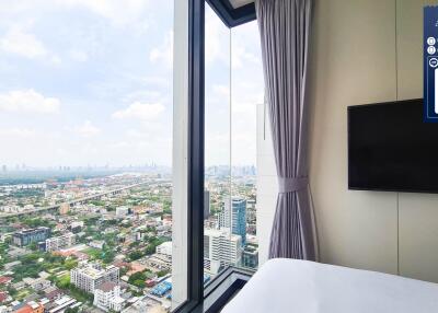 High-rise bedroom with city view