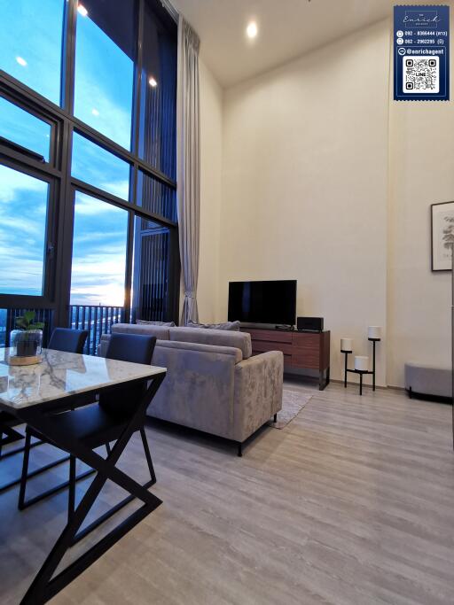 Spacious living room with high ceilings and large windows