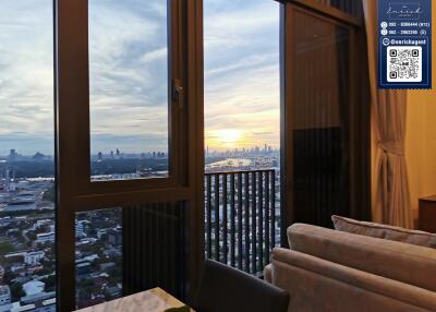 Living room with a view of city skyline at sunset