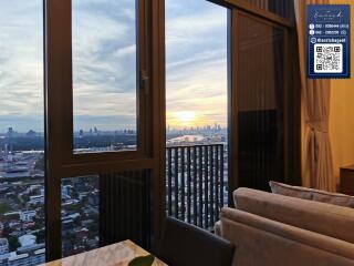 Living room with a view of city skyline at sunset