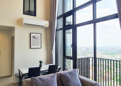 Spacious living room with large windows and a balcony view