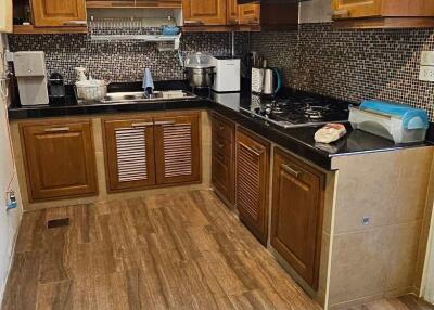 Spacious kitchen with wooden cabinets and modern appliances