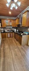 Spacious kitchen with wooden cabinets and modern appliances