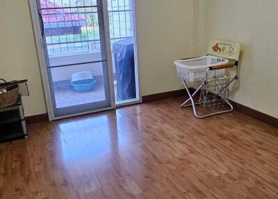 Empty room with wooden flooring and a balcony door