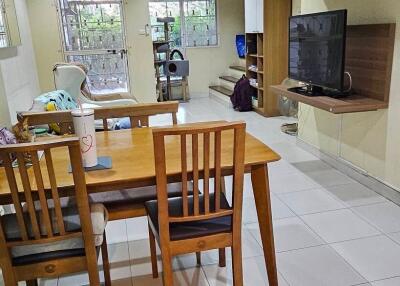 Spacious living area with dining table and TV