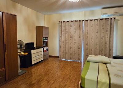 Neat bedroom with wooden flooring and a wardrobe