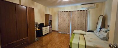 Neat bedroom with wooden flooring and a wardrobe