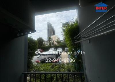 Balcony view with cityscape and parking area