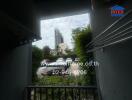 Balcony view with cityscape and parking area