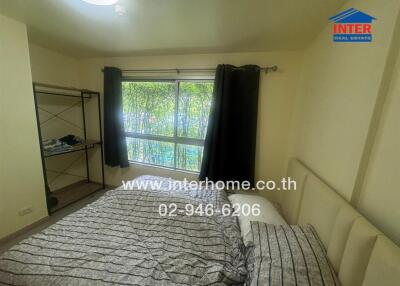 Spacious bedroom with a large window and a double bed