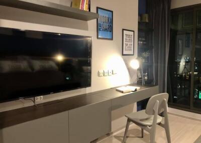 Modern study room with desk, chair, and wall-mounted TV