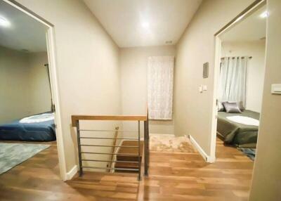 Hallway in a residential property with wooden floors and access to multiple rooms