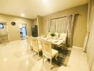 Spacious dining room with a set dining table, chairs, and elegant curtains