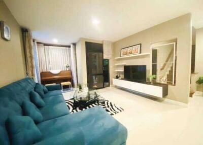 Modern living room with blue sofa and entertainment unit