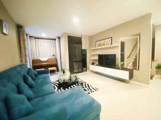 Modern living room with blue sofa and entertainment unit