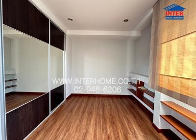 Empty bedroom with wooden floors and large closets