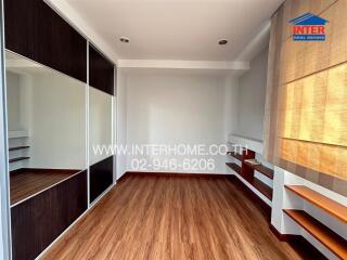 Empty bedroom with wooden floors and large closets