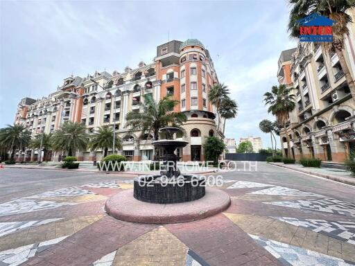 Exterior view of a residential building with a central fountain