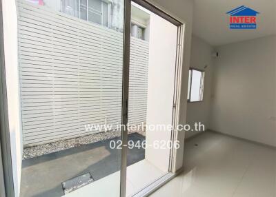 Empty room with sliding glass door leading to an outdoor area