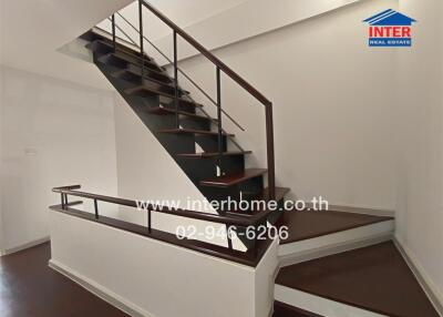 Wooden staircase with metal railings in a modern home