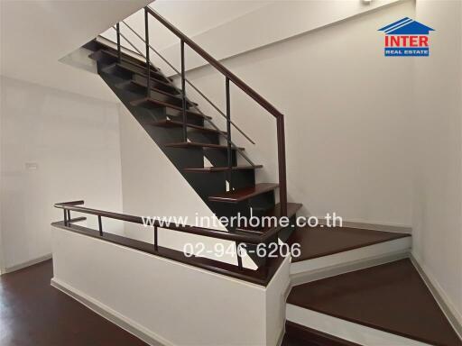 Wooden staircase with metal railings in a modern home