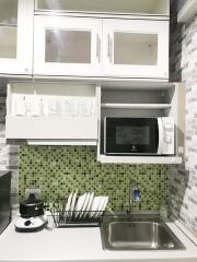 Modern kitchen with green mosaic backsplash