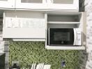 Modern kitchen with green mosaic backsplash