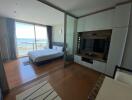 Bedroom with a view of the sea, featuring a bed, built-in wardrobe, and a TV unit