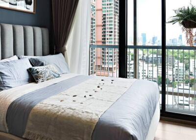 Modern bedroom with large window and city view