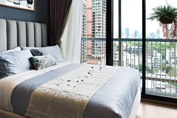 Modern bedroom with large window and city view