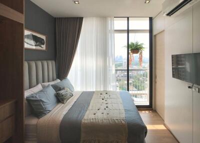 Modern bedroom with large window and city view