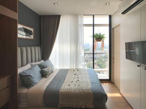 Modern bedroom with large window and city view