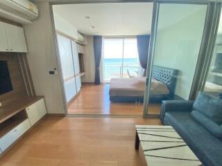 Modern living area with adjacent bedroom and ocean view