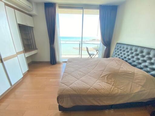 Bedroom with a large window and ocean view