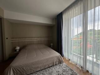 Modern bedroom with large windows and natural light