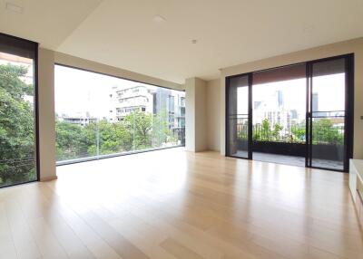 Spacious living room with large windows and city view