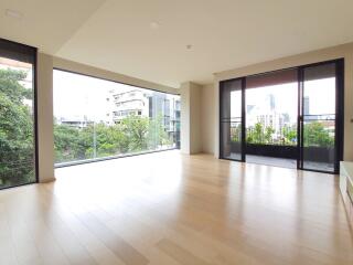 Spacious living room with large windows and city view