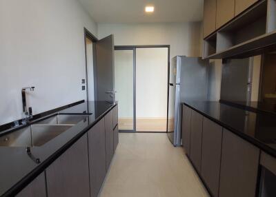 Modern kitchen with dark countertops and ample cabinetry