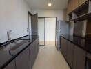 Modern kitchen with dark countertops and ample cabinetry