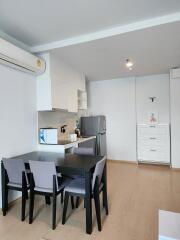 Modern dining area with kitchen in the background