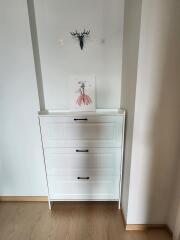 Minimalist hallway with storage dresser and wall decor