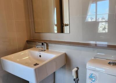 Modern bathroom with sink, mirror, and toilet